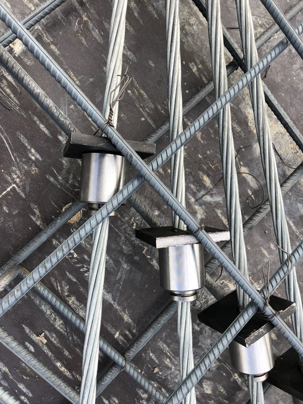 Post tensioning anchor and tendons installed within reinforced concrete structure